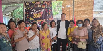 Kelvin Wirawan bersama dengan warga yang mengikuti pengobatan gratis ( Dok Suaranusantara/Ilwan Nehe)
